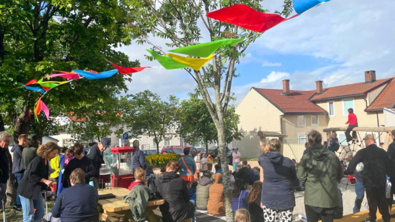 mange mennesker står samlet på en lekeplass